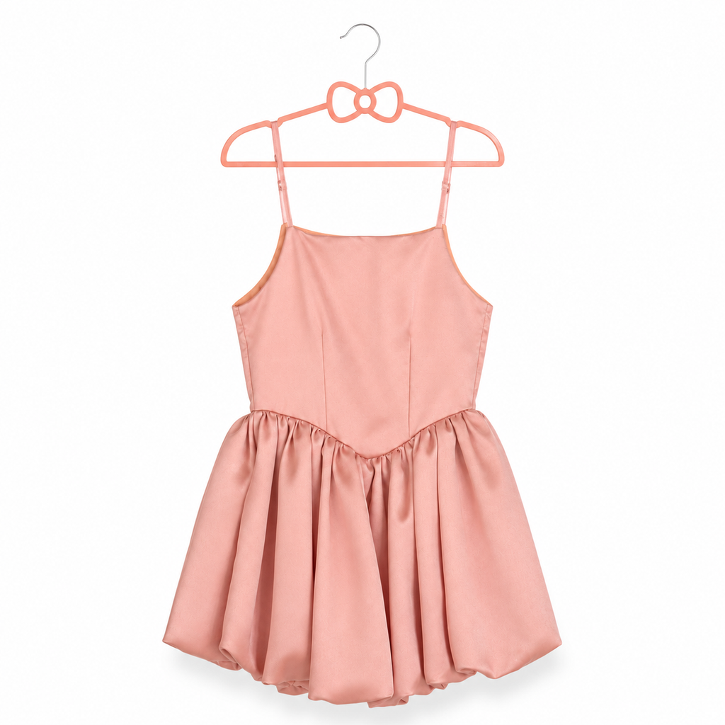 Pink dress on a hanger against a white background