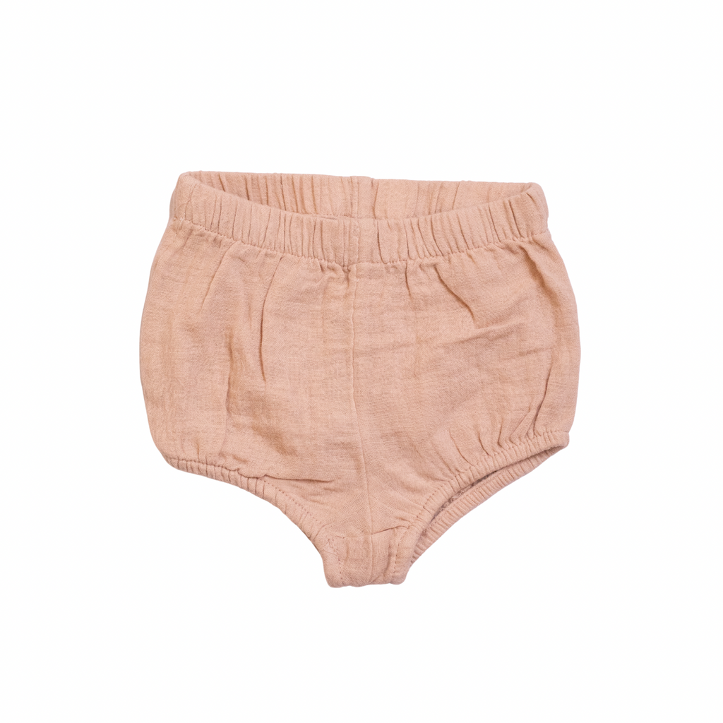 Pink baby bloomers on a white background