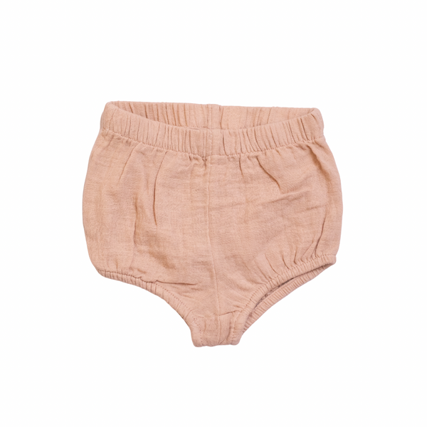 Pink baby bloomers on a white background
