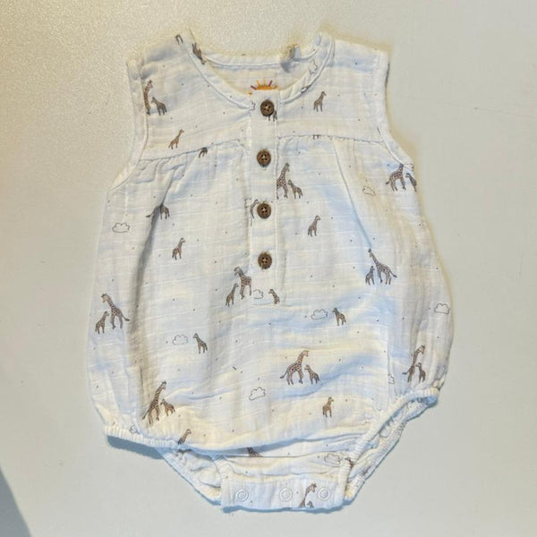 Baby romper with giraffe pattern on a plain background