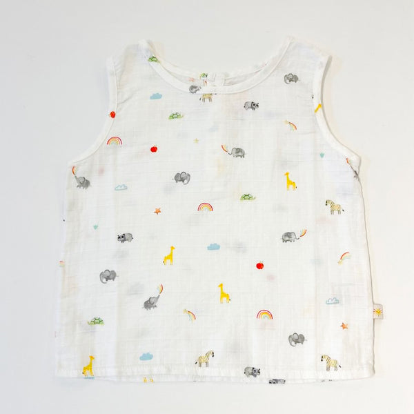 A white muslin vest for babies with a rainbow and elephant pattern.
