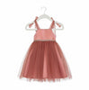 Pink dress with tulle skirt on a white hanger against a white background