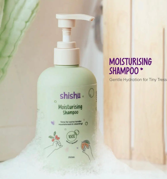 A bottle of Shishu Moisturising Shampoo with a pump dispenser, presented in a setting with a soft focus on baby-related elements, emphasizing gentle hydration for tiny torsos.