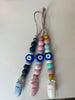 Colorful beaded lanyards with clips on a white background