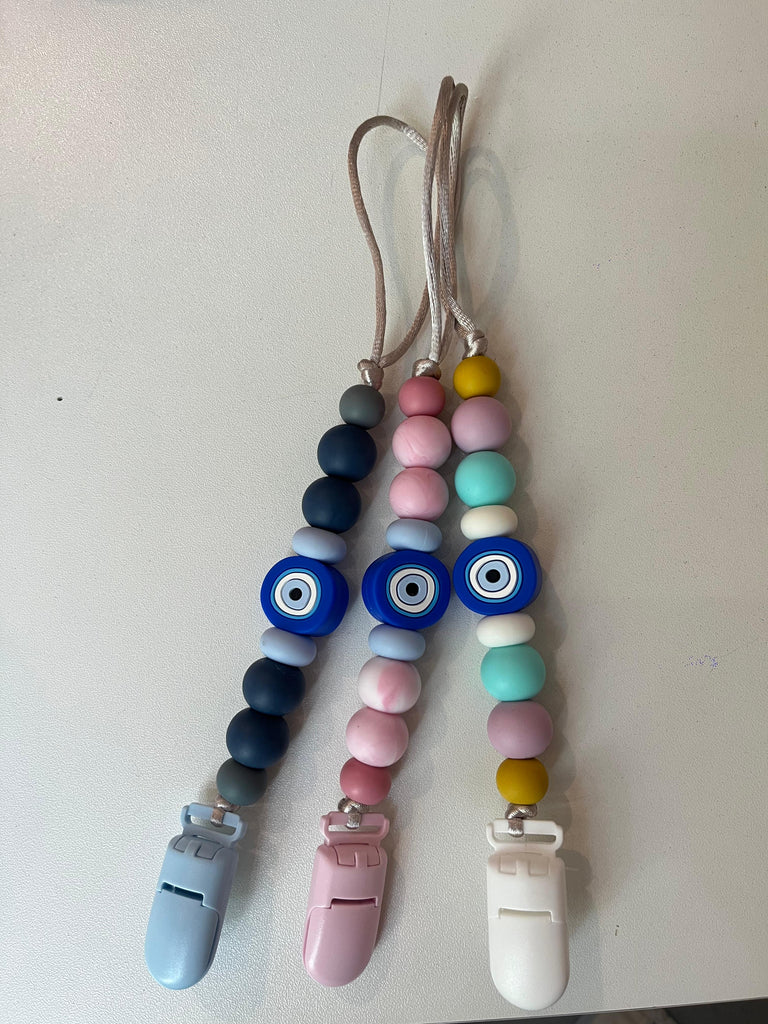 Colorful beaded lanyards with clips on a white background