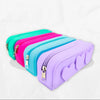 Set of four colorful silicone pouches with zippers on a white background
