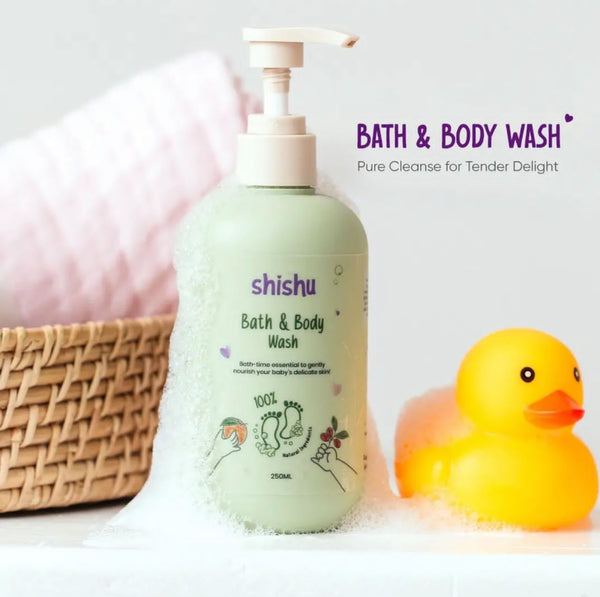 A green bottle of Shishu Baby Bath and Body Wash with a white pump, displayed next to a yellow rubber duck and a basket.