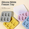 A set of silicone nibble freezer tray in various colors including pink, gray, yellow, and blue.