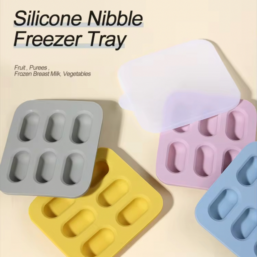 A set of silicone nibble freezer tray in various colors including pink, gray, yellow, and blue.