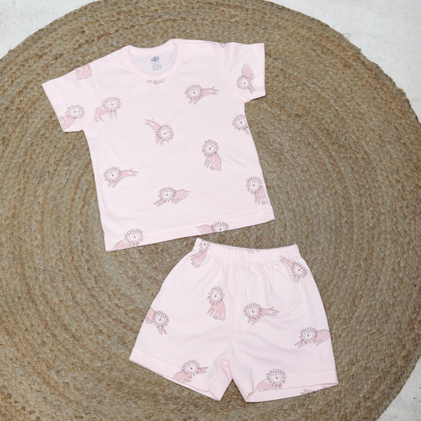 Two pink fabric pieces with a pattern of cartoon characters on a textured surface.
