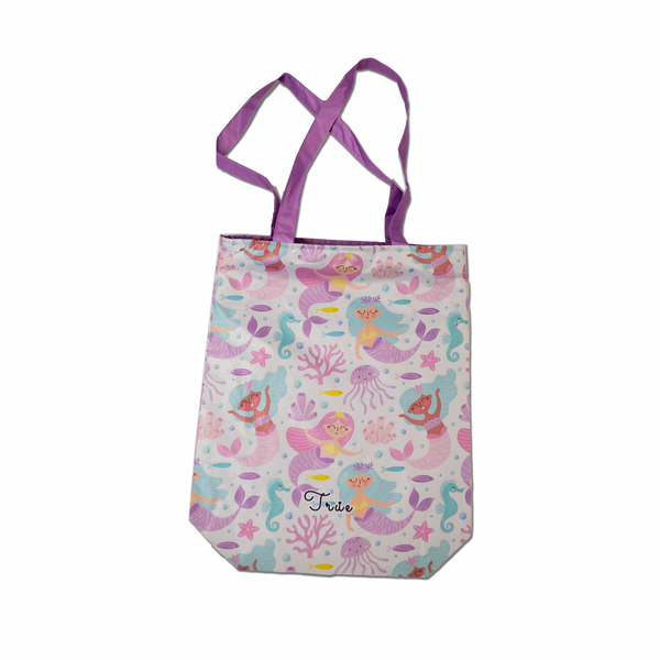 Tote bag with mermaid design and purple handles on a white background