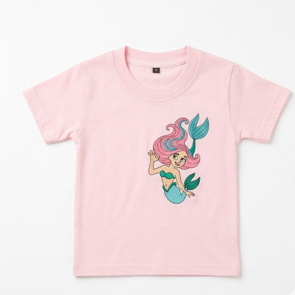 Pink t-shirt with a mermaid graphic on a white background