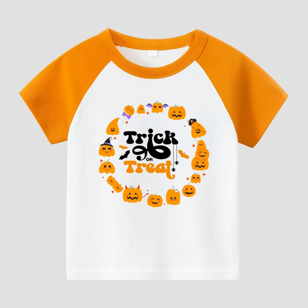 A children's raglan-style short-sleeve T-shirt with a white body and bright orange sleeves/collar. The front has a Halloween-themed graphic with the words 'Trick or Treat' in black and orange, surrounded by small orange pumpkins, bats, and candy illustrations, shown on a light gray background.