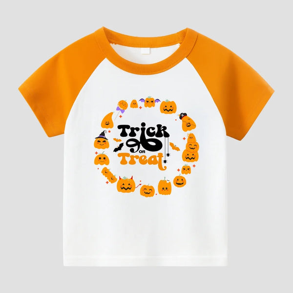 A children's raglan-style short-sleeve T-shirt with a white body and bright orange sleeves/collar. The front has a Halloween-themed graphic with the words 'Trick or Treat' in black and orange, surrounded by small orange pumpkins, bats, and candy illustrations, shown on a light gray background.