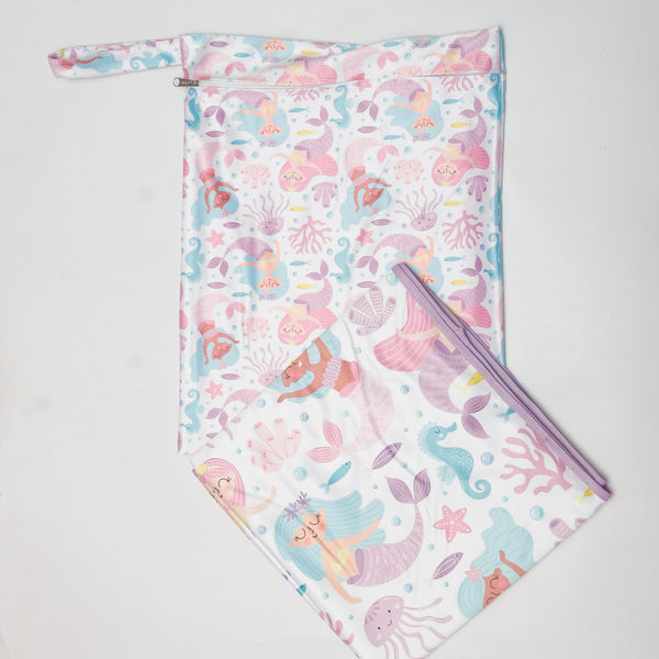 Mermaid-themed pouch and blanket set on a light gray background