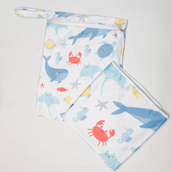 Two fabric swatches with ocean-themed designs on a light gray background