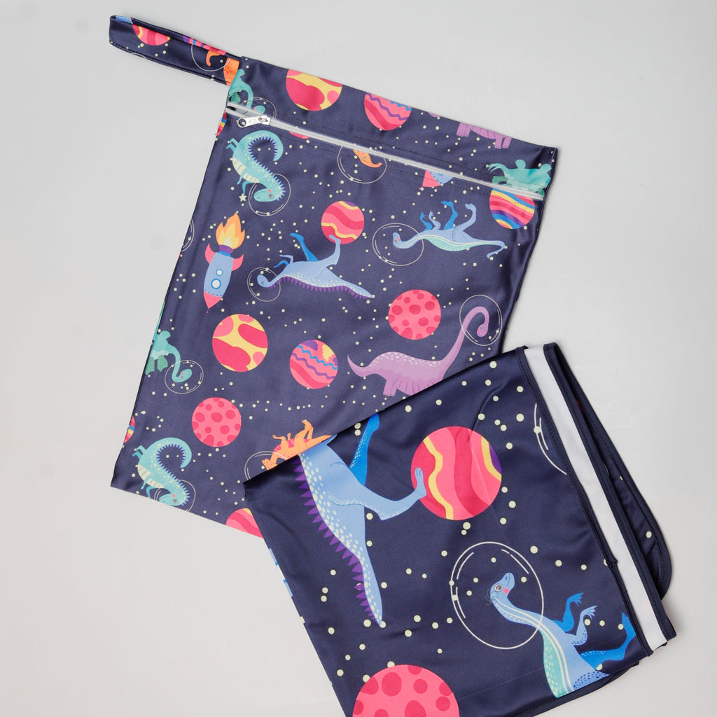 Two pairs of shorts with space-themed designs on a light gray background