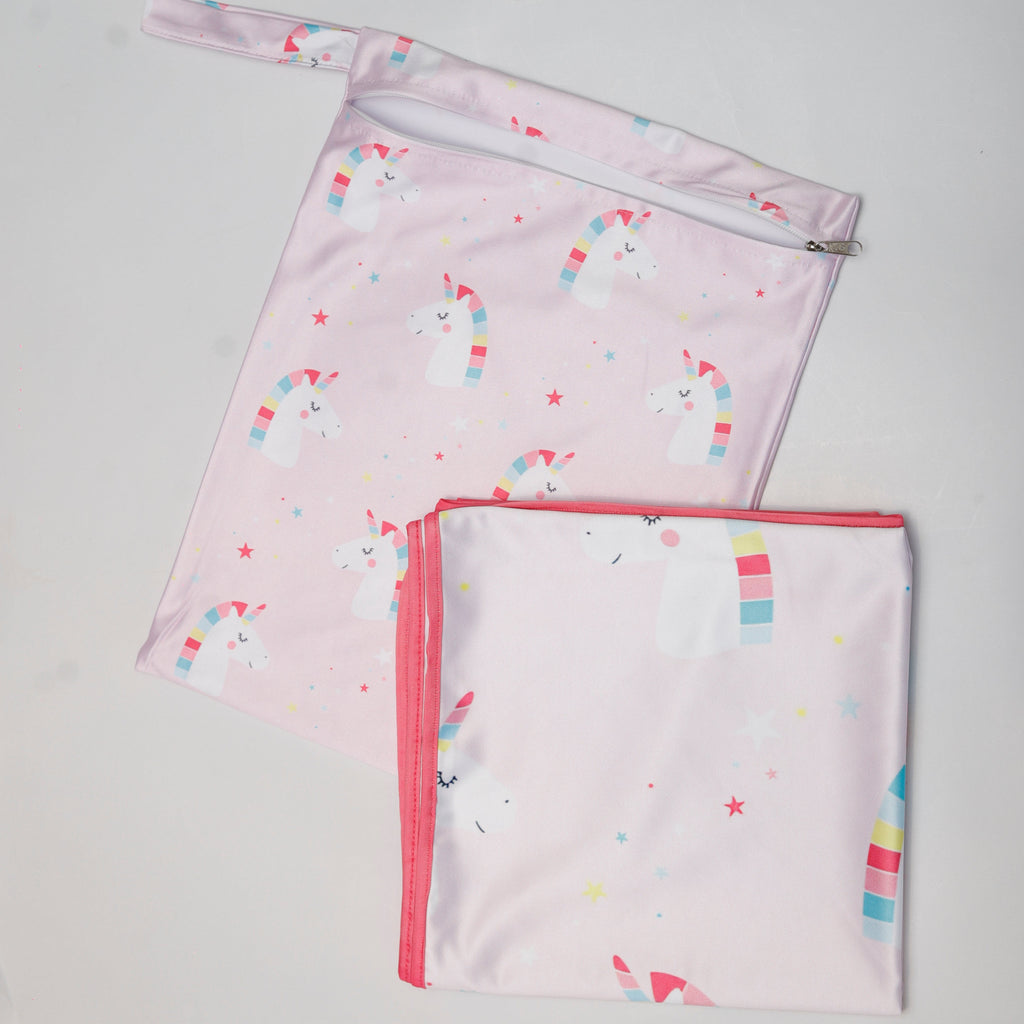 Two pink baby blankets with colorful patterns on a gray background