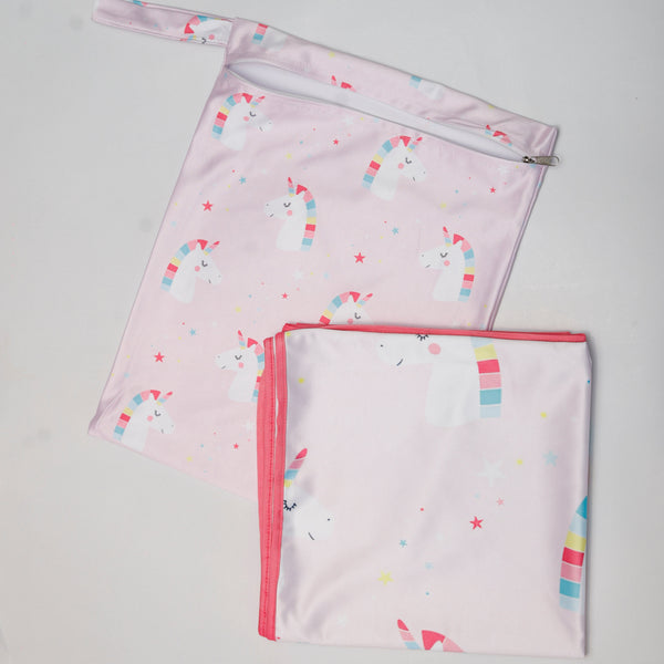 Two pink baby blankets with colorful patterns on a gray background