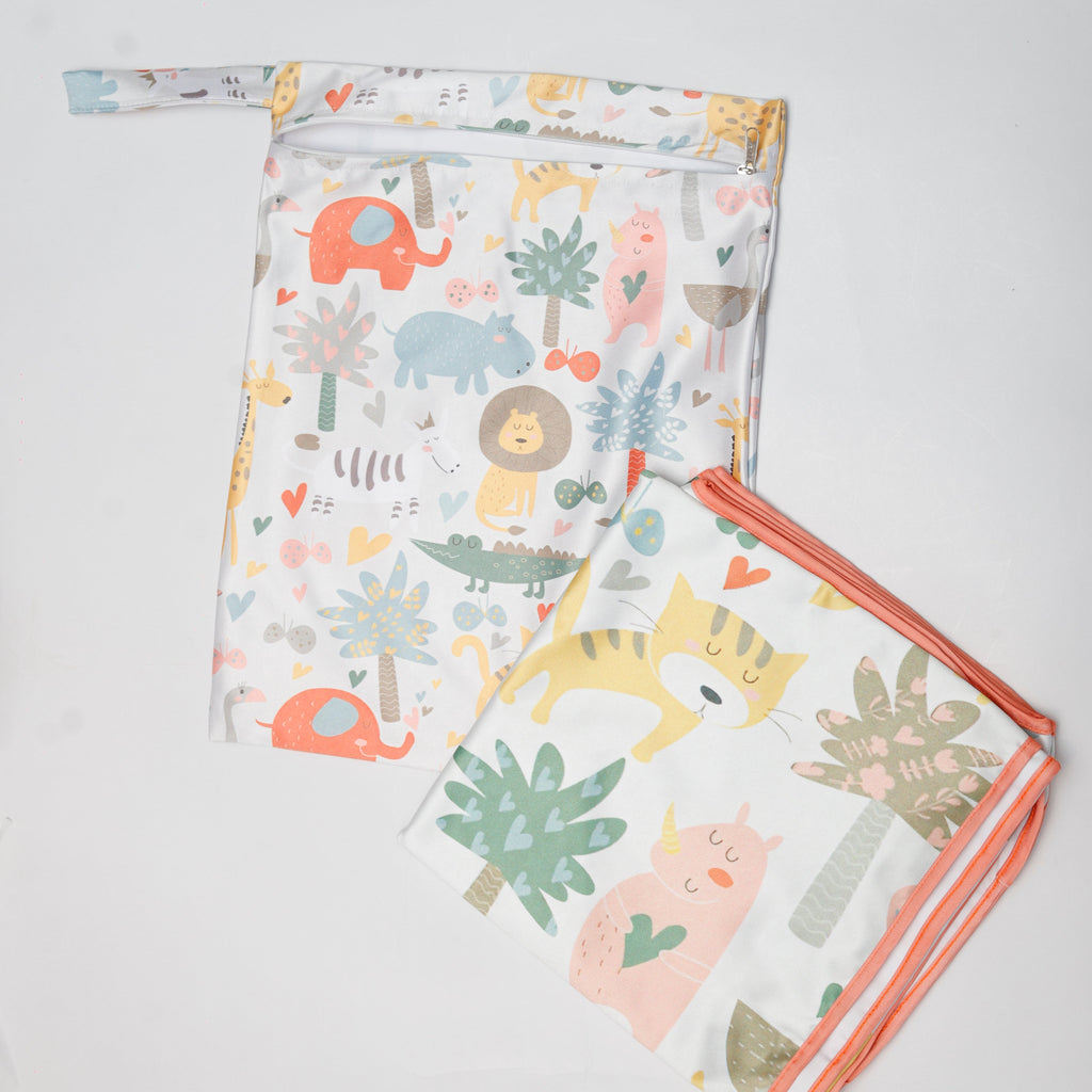 Two baby blankets with animal and plant pattern on a light gray background