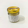 A jar of Whipped Cocoa Butter with Vitamin E by Nue Body Basics, with a label that includes the product name and the statement 'Free from synthetic fragrances'. The jar is sealed with a brown lid and placed on a white background.