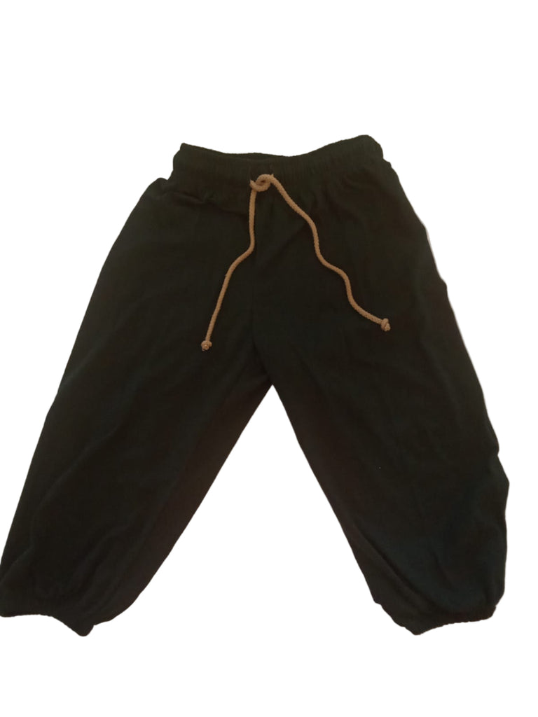 Black pants with a drawstring on a white surface