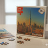 Puzzle set with completed pieces and packaging featuring a cityscape, including Burj Khalifa.