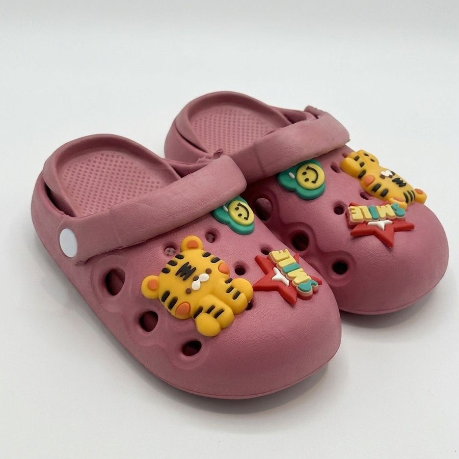 Pink children's clogs with colorful tiger designs on a white background