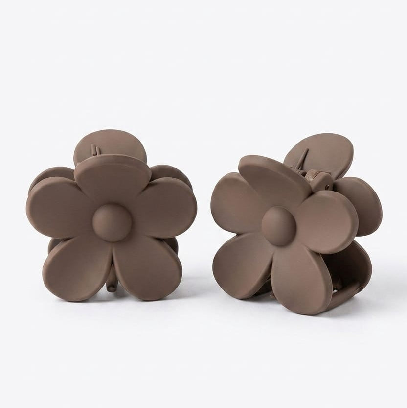 Pair of brown flower-shaped clips on a white background