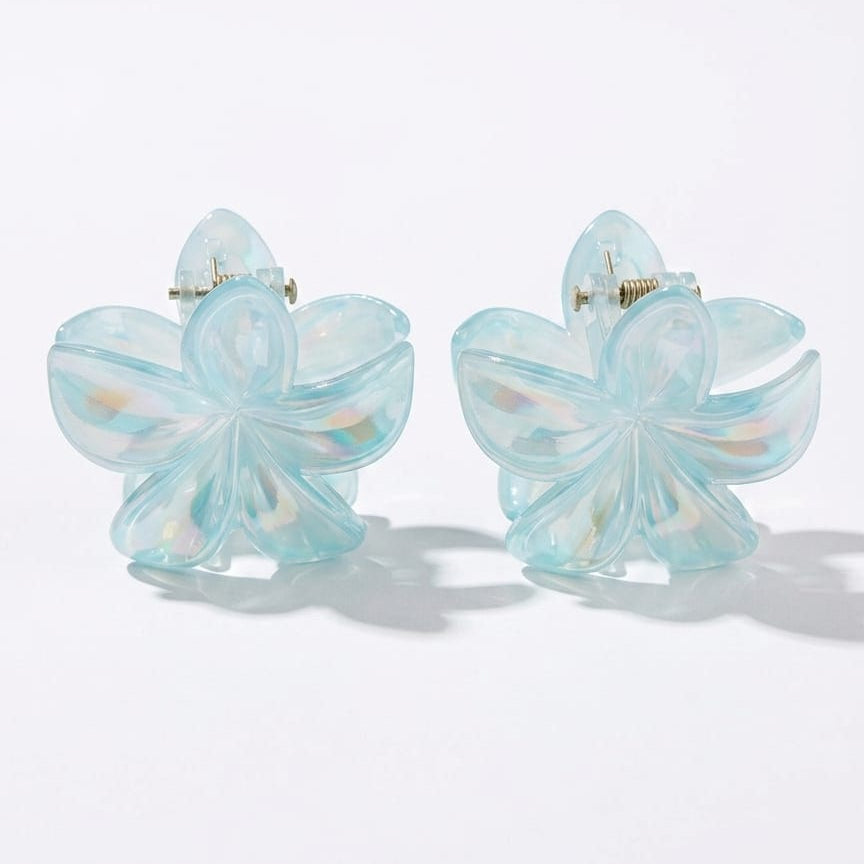 Pair of light blue butterfly-shaped earrings on a white background