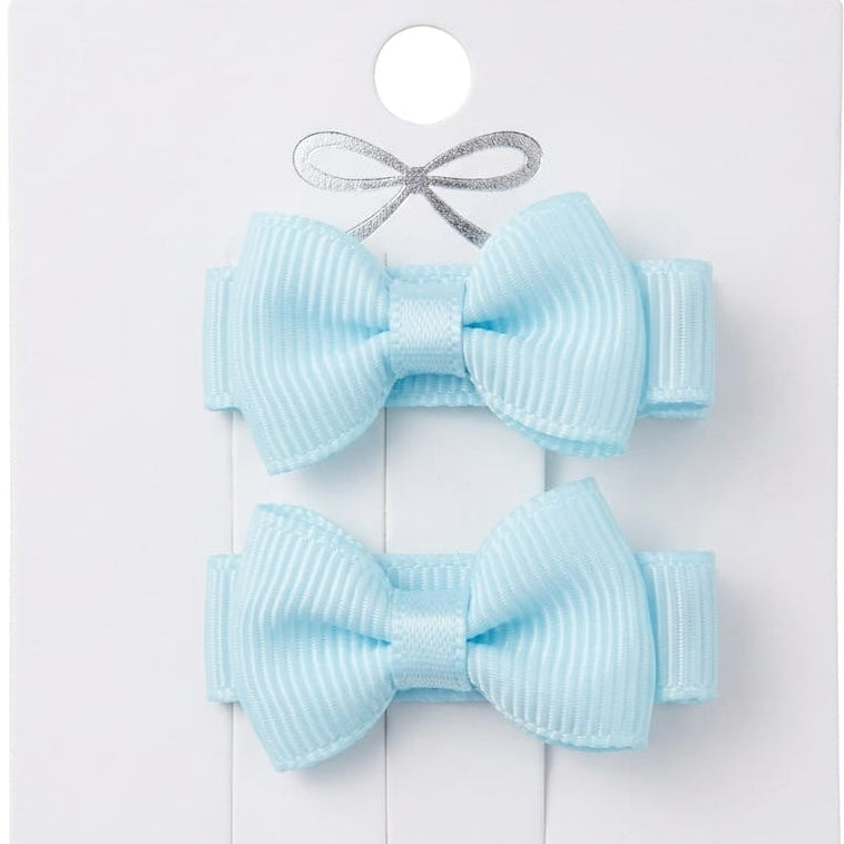 Two light blue hair bows on a white card with a gray ribbon.
