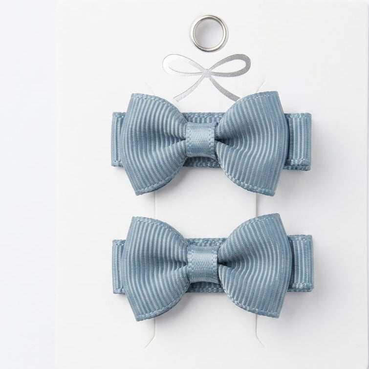 Two blue ribbed hair bows on a white background