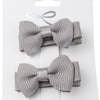 Two gray hair bows on a white card with a white background