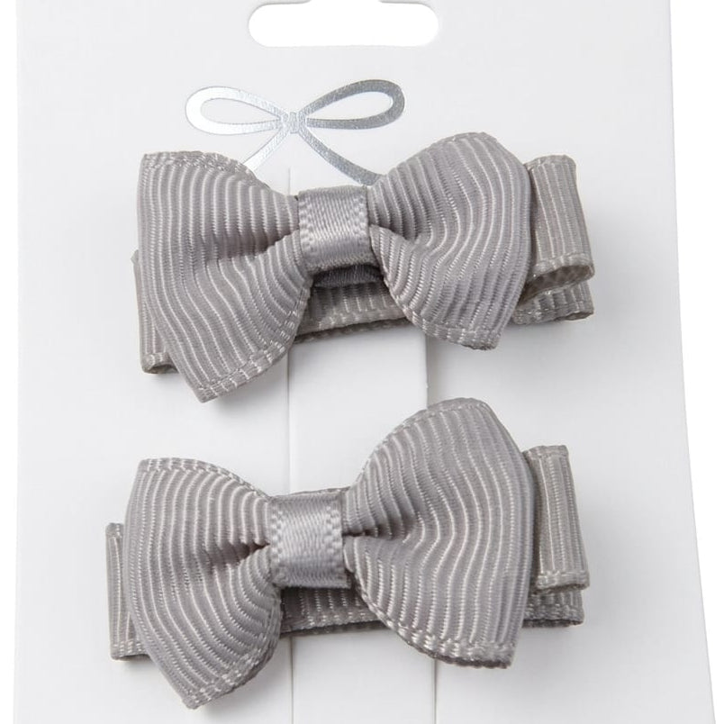 Two gray hair bows on a white card with a white background