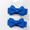 Two blue hair bows on a white card with a clear background