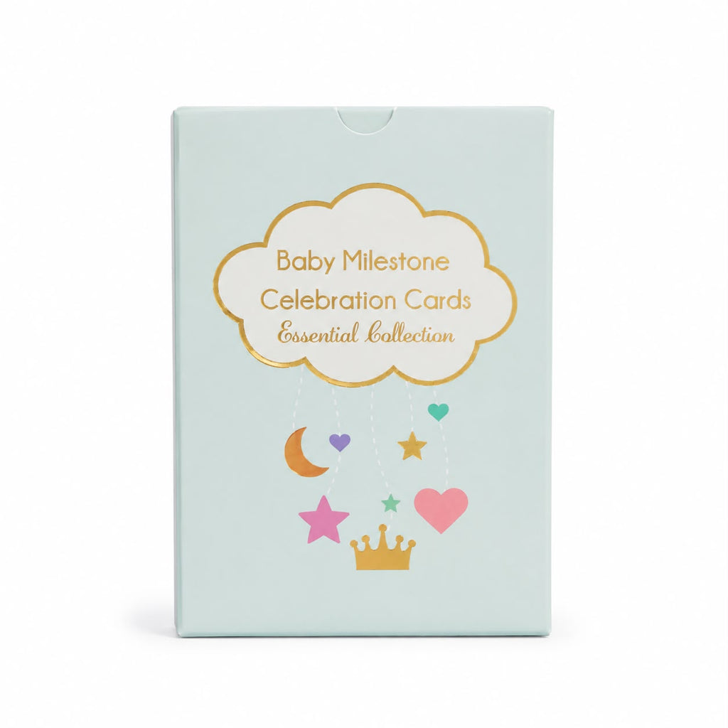 Baby Milestone Celebration Cards Essential Collection card deck box in a pale mint green color with gold foil text and whimsical pastel graphics of stars, hearts, and a crown.