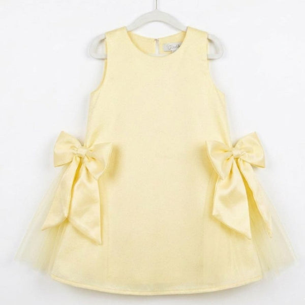 Yellow dress with large bows on a white background