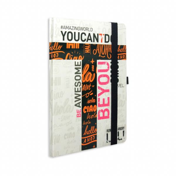 A multicolored journal notebook with text patterns and a black elastic band, featuring a pen holder on the top edge.
