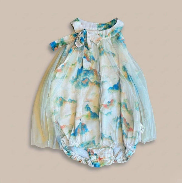 Floral baby romper on a beige background