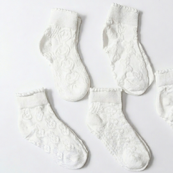 Set of white textured socks on a light gray background