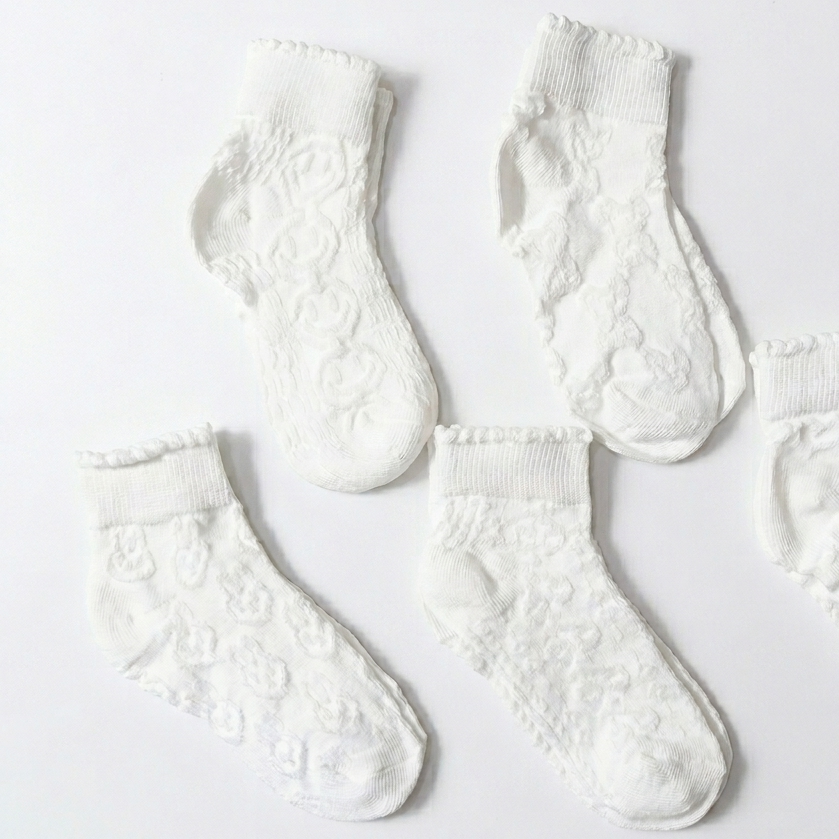 Set of white textured socks on a light gray background