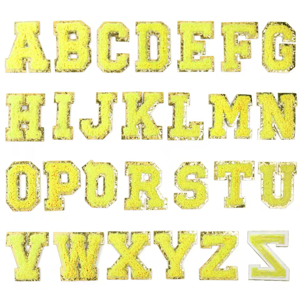 A set of yellow embroidery fabric letter patches, each letter is presented in a different yellow shade, with a bold, embroidered design.