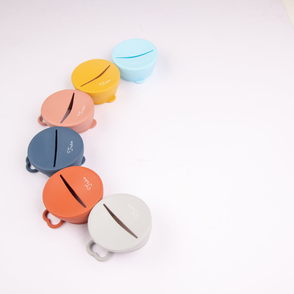 True snack lid in six range of colors, BPA free. A sliced open in the middle for the small hands to go in.