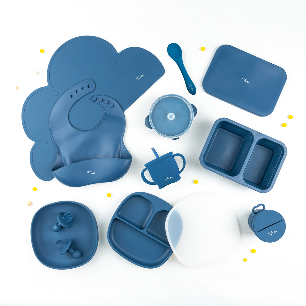 True Kids Tableware Set - Complete set in a range of four-color themes. The set includes a silicone bucket bib, collapsible silicone divided lunch box, smiley face divided silicone plate with lid, a suction bowl with lid, a silicone bowl, a spill-proof two handed straw cup, a spoon, a set of anti choke cutlery and a silicone spoon, a snack lid with cup, and a cloud shaped silicone mat.