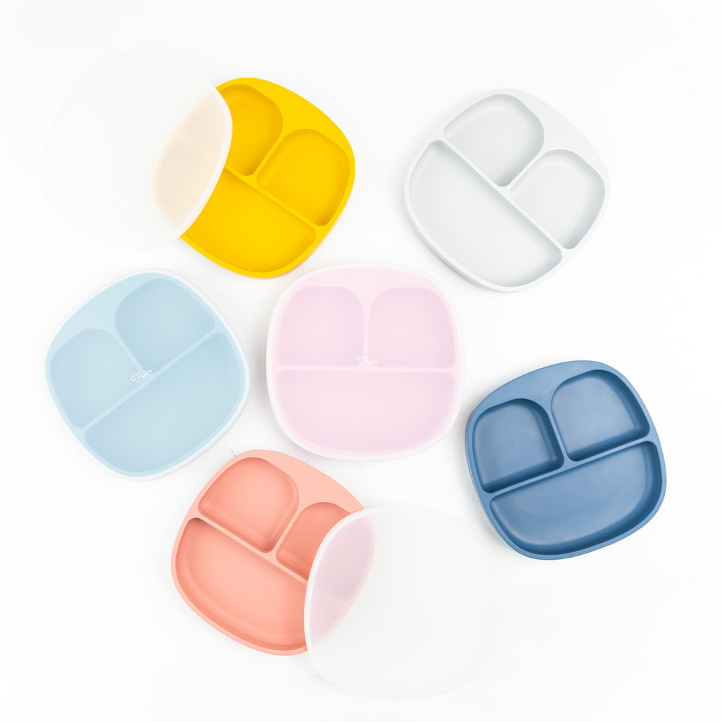 A collection of six colorful silicone divided plates with smile face. Each plate has three compartments of varying sizes to separate food portions.