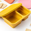 Divided and collapsible silicone lunch box with a lid in seven different colors.