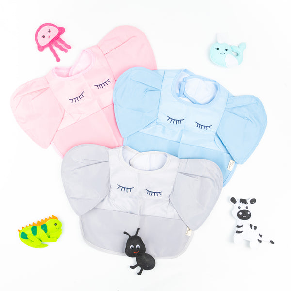 A set of three waterproof elephant bibs in pink, blue, and gray